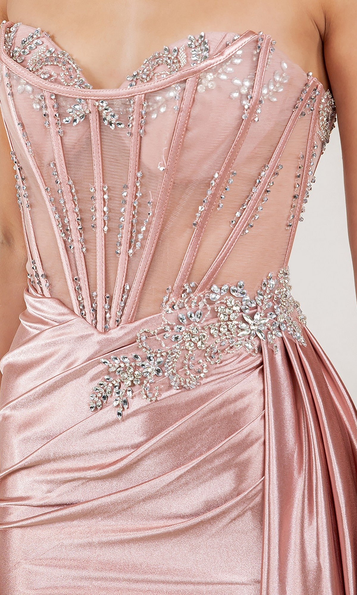 A close-up of the Cinderella Couture 8511J, a strapless blush pink long prom dress with a satin skirt, sheer boned bodice, and detailed silver sequin and crystal beadwork embellishments.